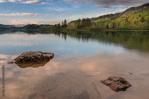 French landscape - Jura. View over the lake of Ilay in the Jura mountains (France) at sunset with rock in the foreground. photo