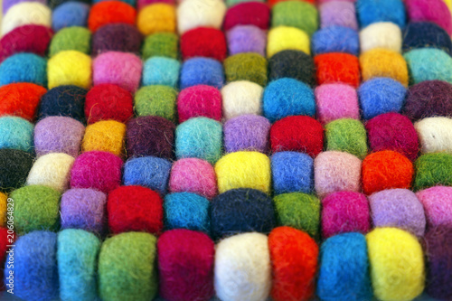 Close up full frame view of a vibrant multi coloured felt booble table mat