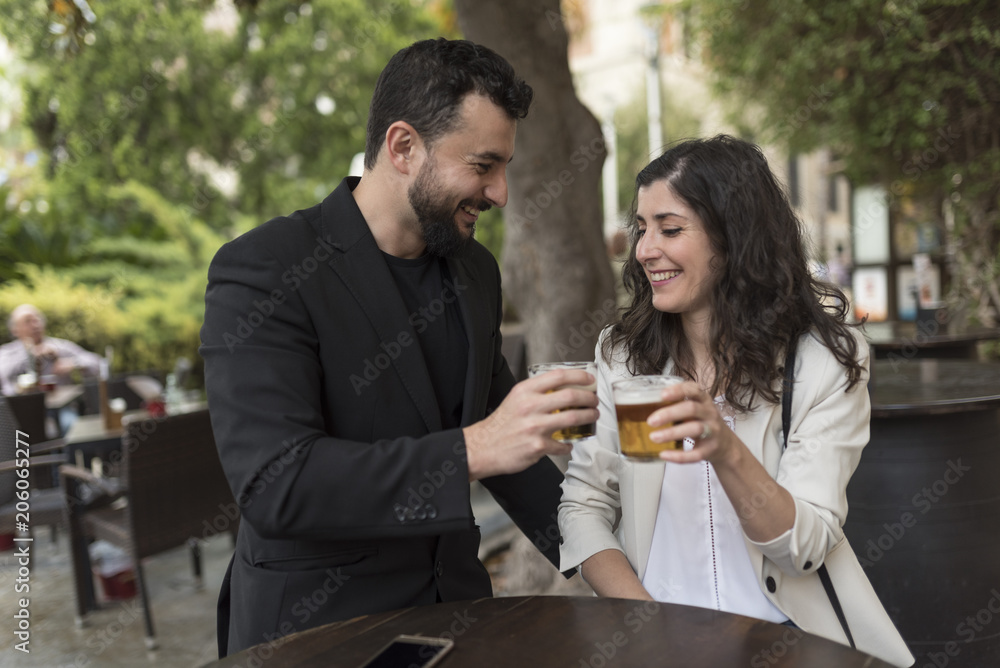 Couple in bar celebratibng anniversary and drinking beer and valentines Couple in bar celebratibng anniversary and drinking beer and valentines