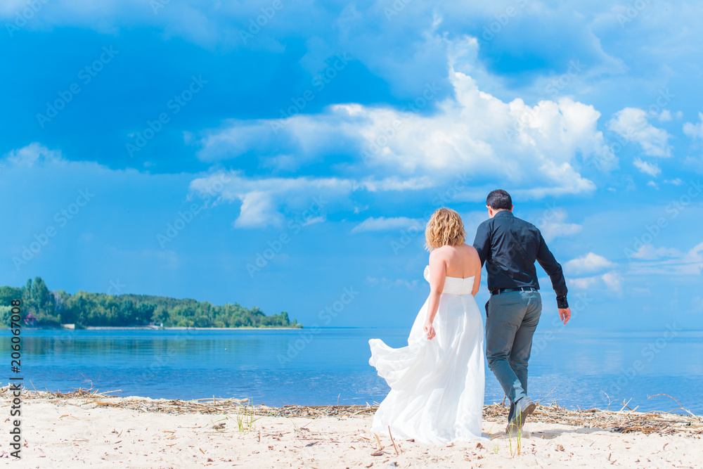 Romantic tenderness bride and groom at sea. Young lady plus size enjoying moments in summer time. Beautiful bride posing with groom in her wedding day, pretty girl in a wedding dress Romantic tenderness bride and groom at sea. Young lady plus size enjoying moments in summer time. Beautiful bride posing with groom in her wedding day, pretty girl in a wedding dress