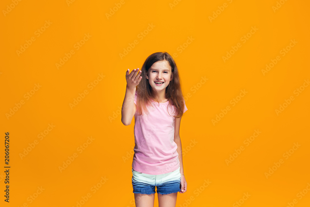 Beautiful teen girl looking suprised isolated on orange Beautiful teen girl looking suprised isolated on orange