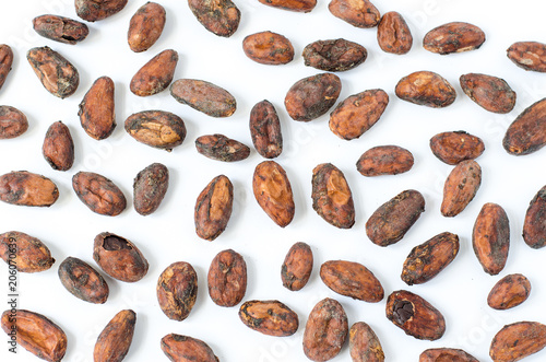 Raw organic unpeeled cacao beans pattern on white background
