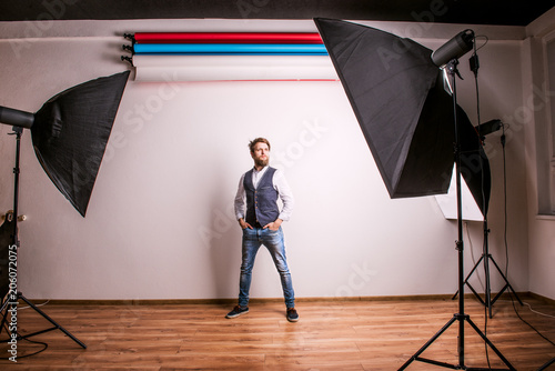 Portrait of a young hipster man or model in a studio. Copy space.