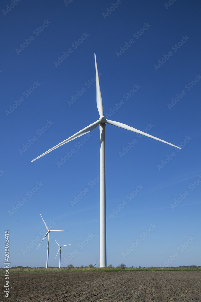 Wind energy turbines on sunset sky background, Energy generator nature friendly. Spring field. Wind energy turbines on sunset sky background, Energy generator nature friendly. Spring field.