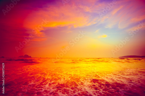 Fototapeta Naklejka Na Ścianę i Meble -  Beautiful tropical sunset in Krabi, Thailand. Dramatic and picturesque evening scene. Ocean waves and colorful cloudy sky in the background. Nature landscape. Travel background. Bright orange toning