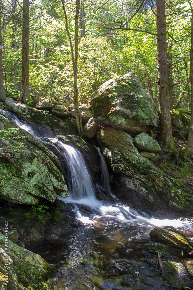 Waterfall cascading by large rocks