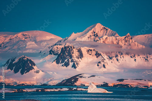 The Antarctic peninsula mountain range that was shot during the extreme expedition to the Vernadsky Research Base. The beauty of snow-covered mountain crest and Pacific Ocean.