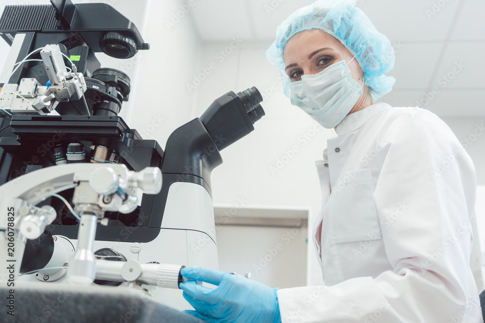 Woman doctor working in medical lab with manipulator and microscope Woman doctor working in medical lab with manipulator and microscope