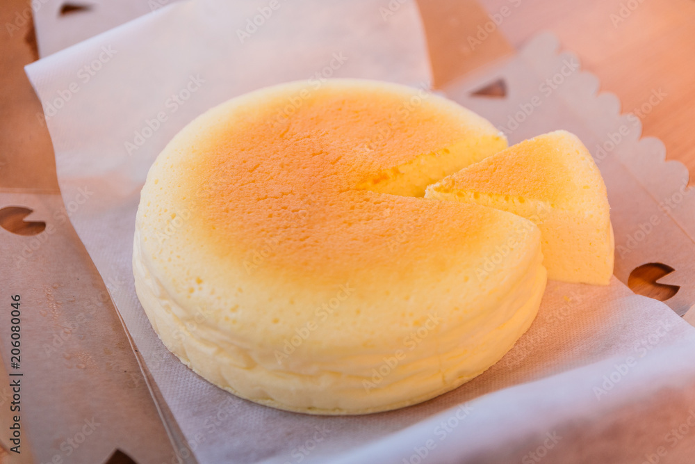 Japanese Cheesecake with seperated slice in opened paper box. Soft and sweet.