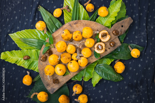 Fresh ripe mushmula or loquat fruit. Good for breakfast and desserts. Evergreen subtropical tree orange sweet and juicy fruit widely spread in Georgia, Japan, Korea, Spain and other asian countries. photo