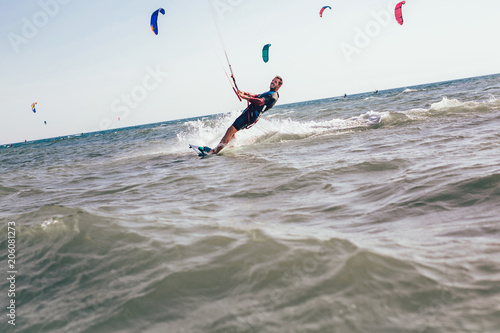 Kitesurfing Kiteboarding action photos man among waves quickly goes