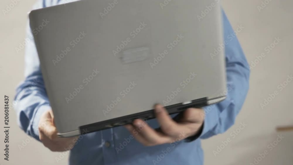 Man working with laptop and blueprints and checking wall at new home
Man working with laptop and blueprints and checking wall at new home