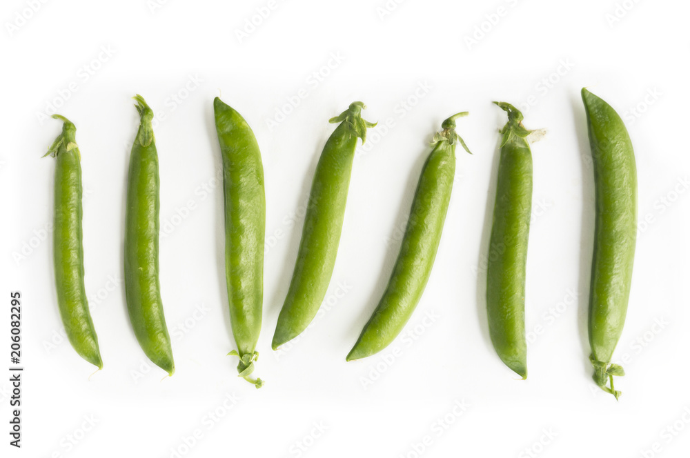 Green peas isolated on a white background. Vegetables with copy space for text. Fresh green peas on a white background. Studio photo. Green peas isolated on a white background. Vegetables with copy space for text. Fresh green peas on a white background. Studio photo.