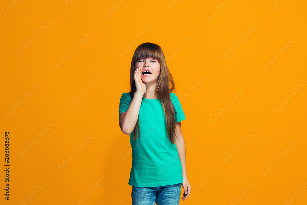 Isolated on yellow young casual teen girl shouting at studio Isolated on yellow young casual teen girl shouting at studio