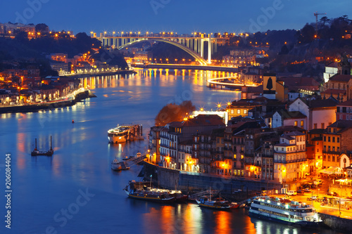 Picturesque aerial view of Old town of Porto, Ribeira and bridge with mirror reflections in the Douro River during evening blue hour, Portugal © Kavalenkava