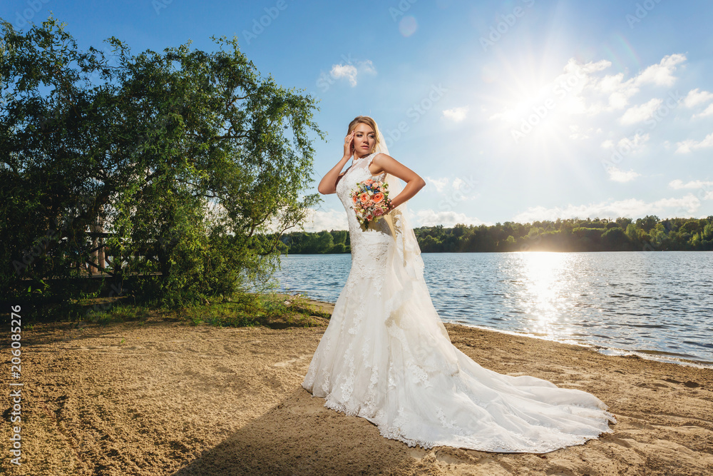 Elegant bride near river or lake. Elegant bride near river or lake.