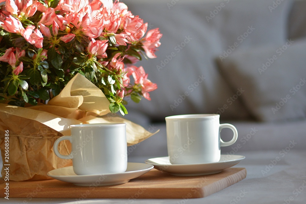 coffee in a white cup with azalea flower