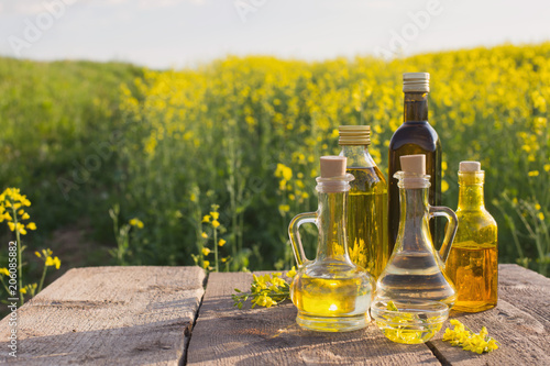 rapeseed oil on wooden table in field