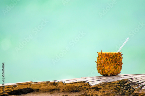 Pineapple coctain on light green background photo