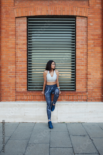 Fitness young woman taking a rest during urban outside training