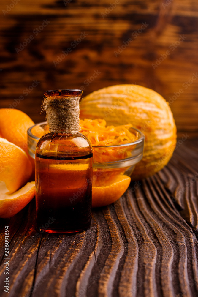 orange essential oil on a wooden background orange essential oil on a wooden background