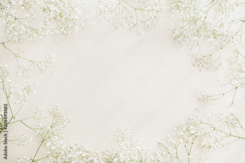 Frame with copy space of white gypsophila flower bouquet pattern. Flat lay, top view festive background. Frame with copy space of white gypsophila flower bouquet pattern. Flat lay, top view festive background.