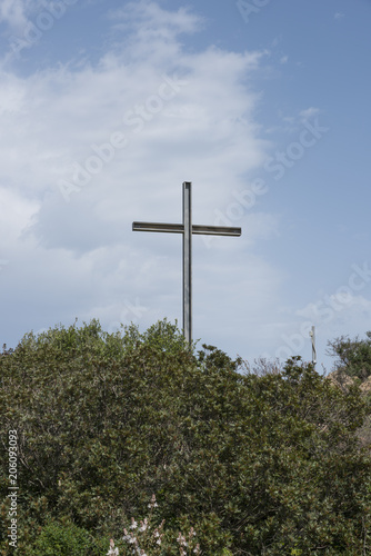 metal cross on a hill in sardinia 