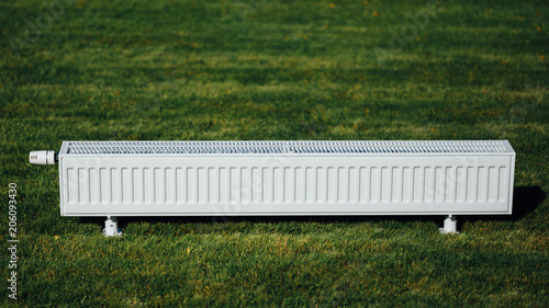 Εκτύπωση καμβά radiator on green lawn, ecological heating concept
