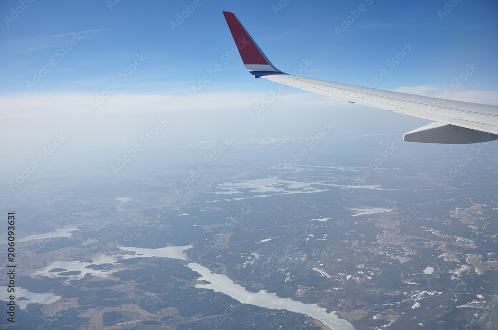 Norwegian landscape under the wings of an airplane flying over the clouds. Norwegian landscape under the wings of an airplane flying over the clouds.