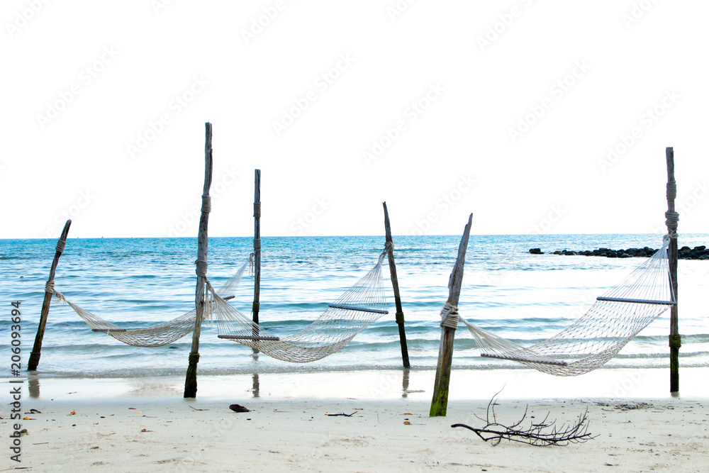 hammocks on beach blue sea colors white sand sky background seascape, Summer Travel concepts (photos that have room for text on the image.) hammocks on beach blue sea colors white sand sky background seascape, Summer Travel concepts (photos that have room for text on the image.)