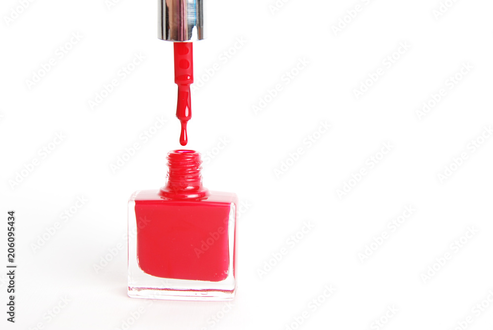 Fototapeta premium Nail Red Polish Flowing from the Bottle on White Background Beauty Fashion
