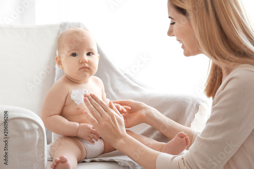 Woman applying body cream o...
