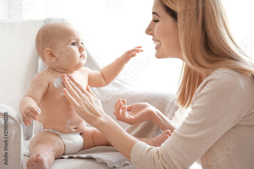 Woman applying body cream o...