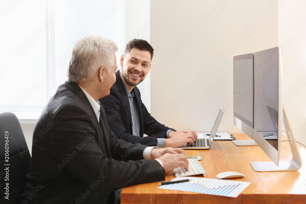 Male brokers working in office. Finance trading concept Male brokers working in office. Finance trading concept