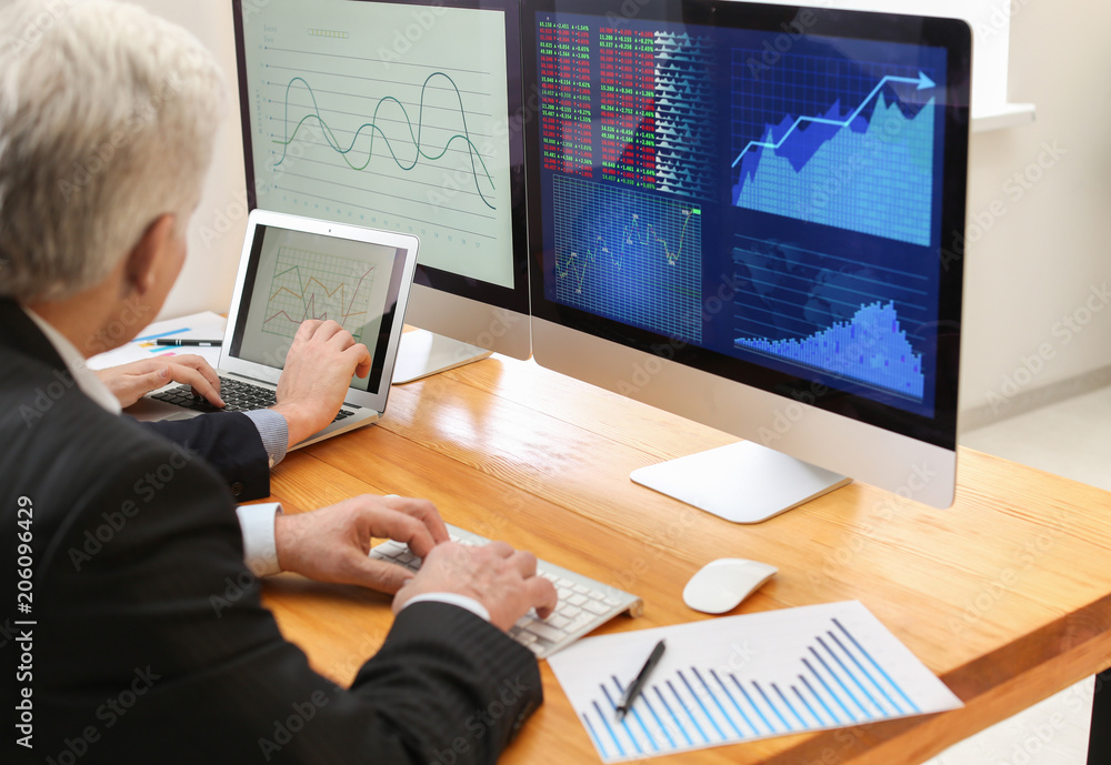 Male brokers working in office. Finance trading concept Male brokers working in office. Finance trading concept