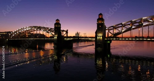 Aerial beautiful sunset view of the bridge with towers at night with the illuminated light, Saint Petersburg, Russia