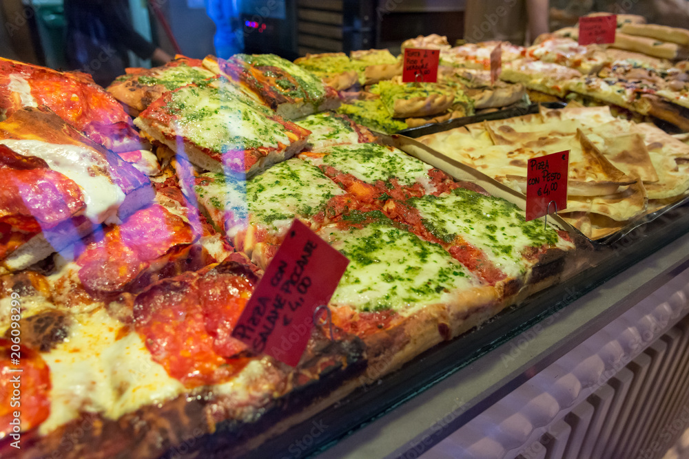 Obraz premium Local bakery selling delicious pizzas and focaccia bread.