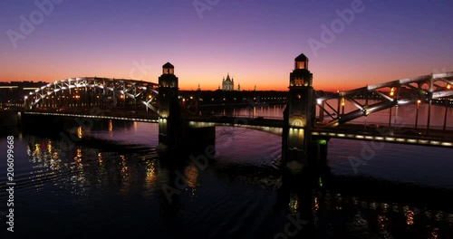 Aerial beautiful sunset view of the bridge with towers at night with the illuminated light, Saint Petersburg, Russia