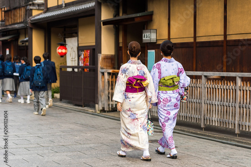 Girls in a kimono on a city street, Kyoto, Japan. Copy space for text. © ggfoto
