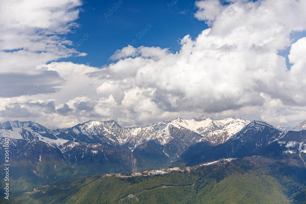 Fototapeta premium Amazing views in the Caucasus mountains. Snow-capped peaks, blue sky, sunny day
