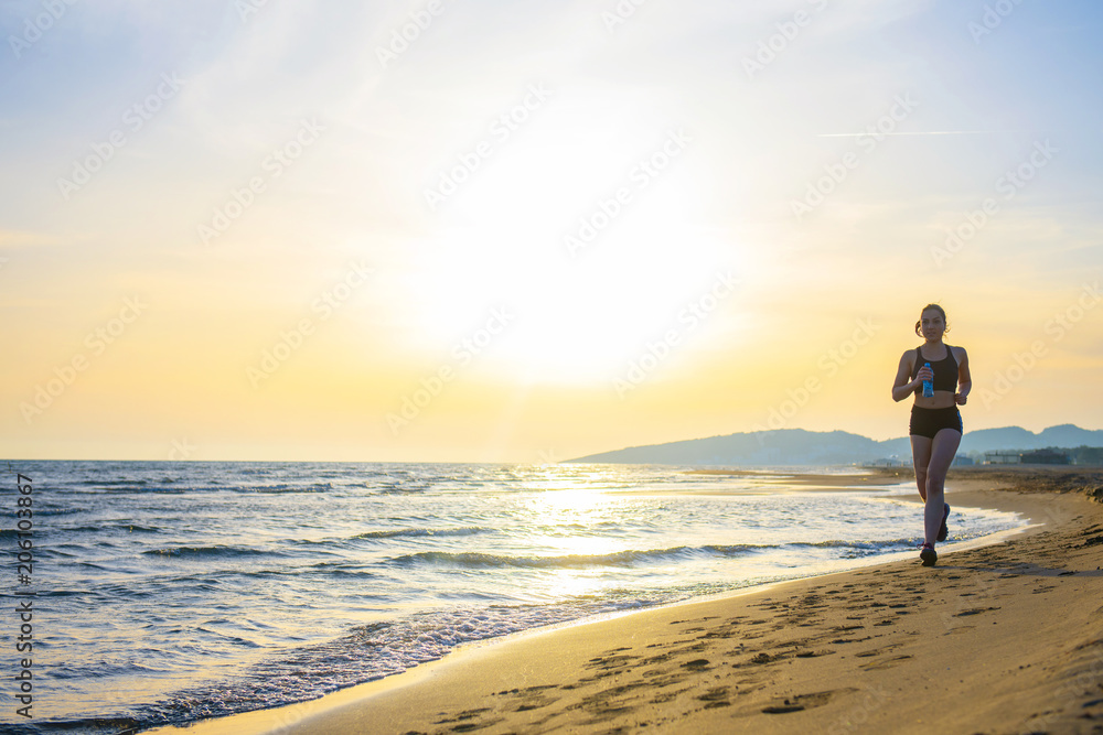 Healthy young fitness woman runner running on sunrise seaside trail Healthy young fitness woman runner running on sunrise seaside trail
