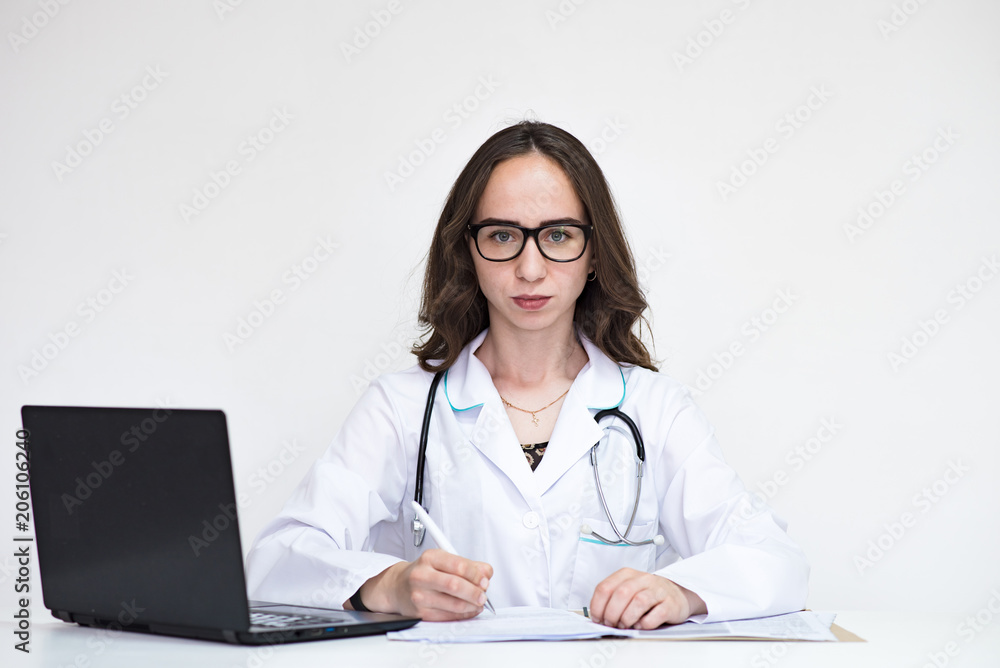 Portrait of beautiful brunette doctor girl on white background with laptop. Portrait of beautiful brunette doctor girl on white background with laptop.