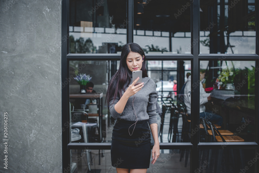 Portrait of young businesswoman use mobile phone while sitting in comfortable coffee shop during work break charming happy female reading fashion news on cell telephone Portrait of young businesswoman use mobile phone while sitting in comfortable coffee shop during work break charming happy female reading fashion news on cell telephone