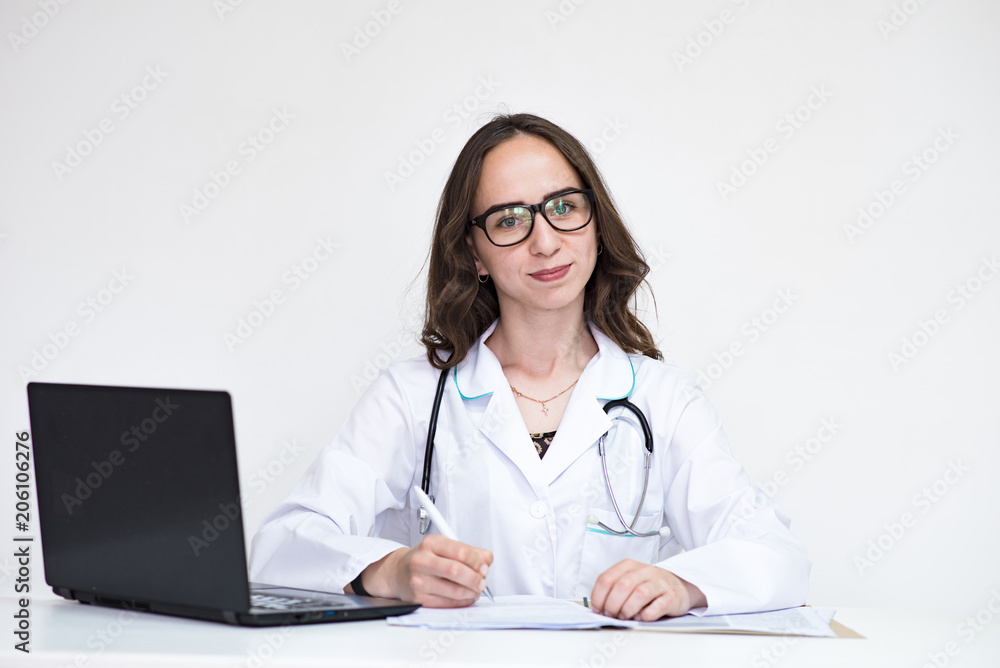 Portrait of beautiful brunette doctor girl on white background with laptop. Portrait of beautiful brunette doctor girl on white background with laptop.