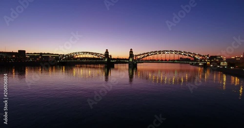 Aerial beautiful sunset view of the bridge with towers at night with the illuminated light, Saint Petersburg, Russia