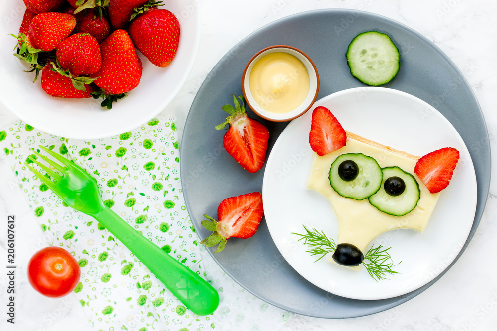 Funny animal face sandwich for children, fox sandwich with cheese and strawberry Funny animal face sandwich for children, fox sandwich with cheese and strawberry