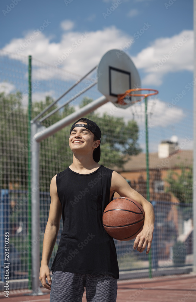 Fototapeta premium Young Man Holding a Basketball Ball
