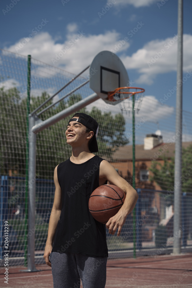 Fototapeta premium Young Man Holding a Basketball Ball