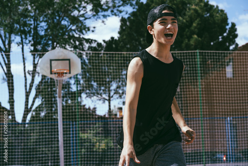 Young boy playing Basketball © karrastock