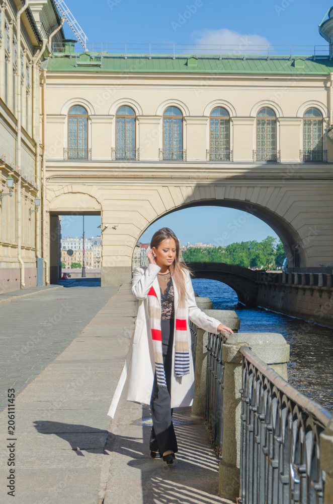 Fototapeta premium Sunny day, beautiful girl on the waterfront